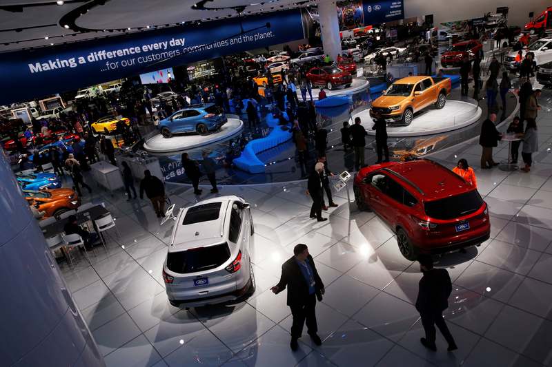 Visitors look at cars in the Ford booth at the North American International Auto Show in Detroit, Michigan January 15, 2018. u00e2u20acu201d Reuters pic