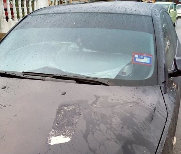 Picture by Facebook user Razali Hamzah who posted the image of his BMW splashed with acid.