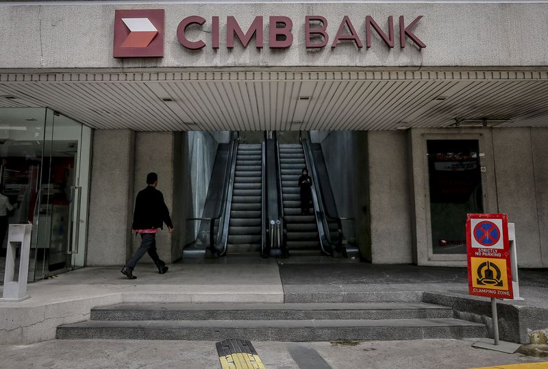 A pedestrian walks past a CIMB Bank Bhd bank branch in Jalan Raja Laut, Kuala Lumpur January 4, 2018. u00e2u20acu201d Picture by Firdaus Latif