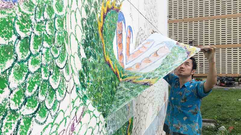 Transferring the mural from the wall onto a parchment paper.