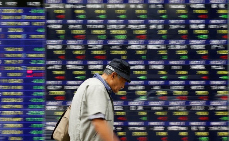 A man walks past an electronic stock quotation board outside a brokerage in Tokyo September 22, 2017. u00e2u20acu201d Reuters pic