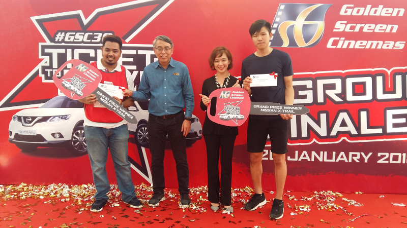 GSC general manager Irving Chee (in blue) and Koh present Asyraf (far left) and Sim the mock keys to their brand-new cars.