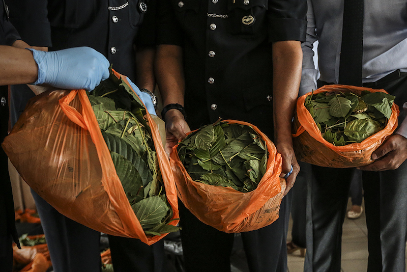 Kuala Lumpur Police Chief Datuk Mazlan Lazim shows the ketum leaves and drinks seized from the lab during a press conference at KL police headquarters January 3, 2018. u00e2u20acu201d Picture by Azneal Ishak