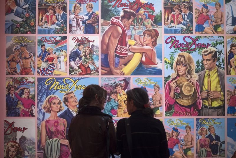 Women stand in front of cover pages of the photo novel u00e2u20acu02dcNous Deuxu00e2u20acu2122 during a press preview of the u00e2u20acu02dcRoman-Photou00e2u20acu2122 exhibition at the Museum of European and Mediterranean Civilisations in Marseille December 11, 2017. u00e2u20acu201c AFP pic