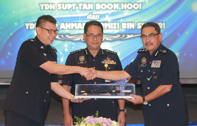 Assistant Commissioner Ahmad Tarmizi Shaari (right) succeeded Supt Tan Boon Hooi, who was the acting Batu Gajah police district chief for the past four months. u00e2u20acu2022 Picture by Marcus Pheong