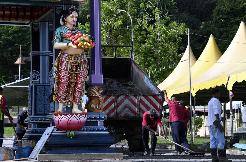 Penang City Council (MBPP) workers paving the road near the Arulmigu Balathandayuthapani Temple in preparation for the Thaipusam celebration, January 20, 2018. u00e2u20acu201d Bernama pic