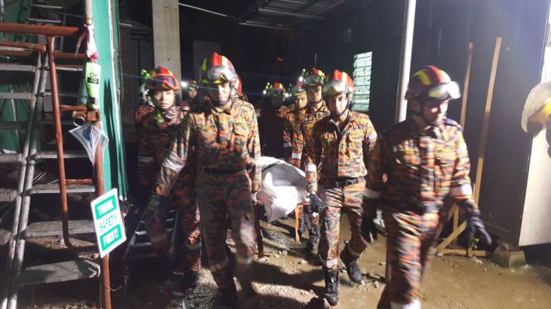 Rescuers carrying the body out of the site after removing rubble and debris for almost 12 hours. u00e2u20acu2022 Picture courtesy of KL Fire and Rescue Department
