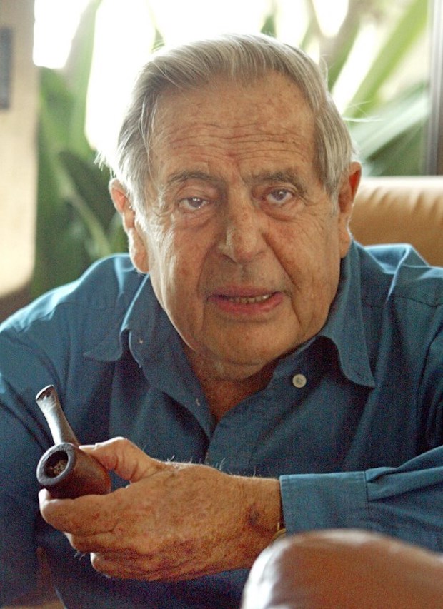 This file photo taken on August 8, 2002 shows Israeli poet Haim Gouri, then-79, as he clutches his pipe while speaking in his home in Jerusalem. u00e2u20acu201d AFP pic