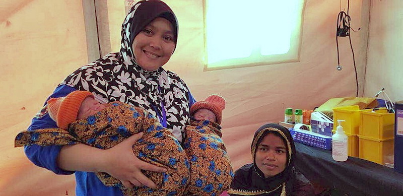 Dr Siti Aishah Tajudin carrying the pair of twins she helped deliver at Coxu00e2u20acu2122s Bazar in Bangladesh. u00e2u20acu201d Bernama pic
