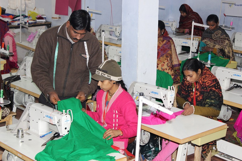 Mohammad Riyaz who set up a solar-powered garment manufacturing unit in Kamlapur village, in the Indian state of Uttar Pradesh, works with one of the 25 women who work for him stitching clothing, January 9, 2018. u00e2u20acu201d Picture courtesy of Thomas Reuters Fou