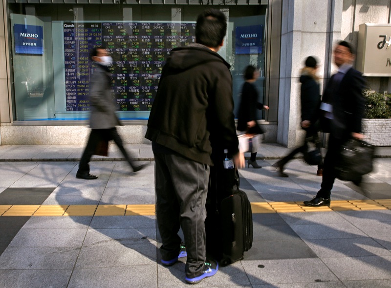 A man looks at an electronic stock quotation board outside a brokerage in Tokyo February 9, 2018.u00e2u20acu201dReuters pic