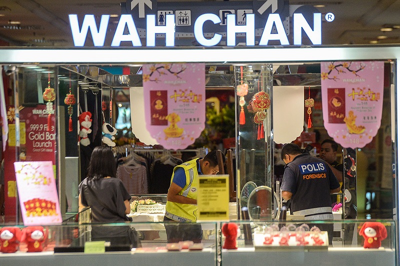 Personnel from the police forensics department examine the crime scene at the Wah Chan jewellery outlet in Giant Kota Damansara February 8, 2018. u00e2u20acu201d Picture by Mukhriz Hazim