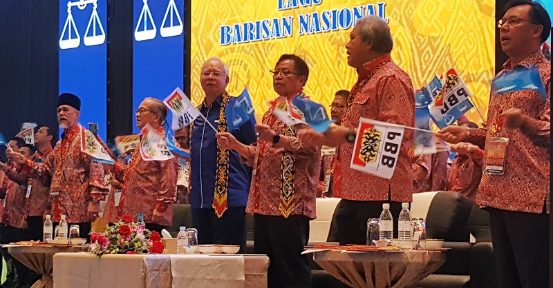 Prime Minister Datuk Seri Najib Razak (fourth from right) and Chief Minister Datuk Patinggi Abang Johari Openg (third from right) waving the Barisan Nasional and PBB flags at the opening of the PBB Triennial Delegates Convention in Kuching February 10, 20