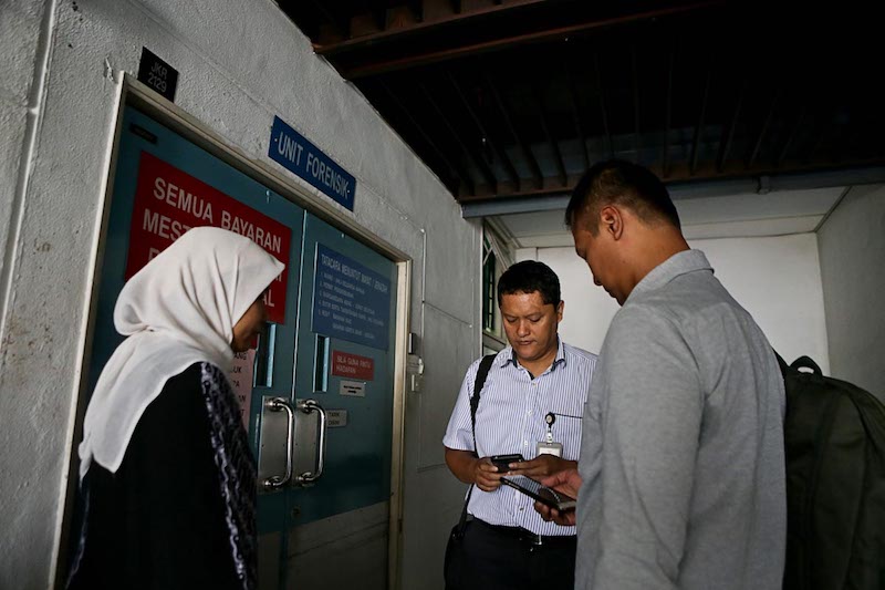 Indonesian Consulate members wait to claim the body of Indonesian maid Adelina Lisao in Seberang Jaya Hospital in Perai February 11, 2018. u00e2u20acu201d Picture by Sayuti Zainudin