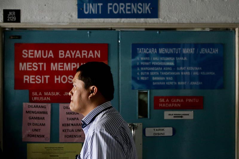 An Indonesian Consulate member waits to claim the body of Indonesian maid Adelina Lisao in Seberang Jaya Hospital in Perai February 11, 2018. u00e2u20acu201d Picture by Sayuti Zainudin