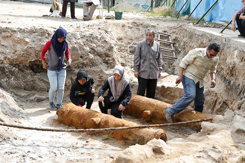 Professor Datuk Mokhtar Saidin looks on as assistants examine recently discovered cannons near the entrance to Fort Cornwallis in George Town February 19, 2018. u00e2u20acu201d Picture by Sayuti Zainudin