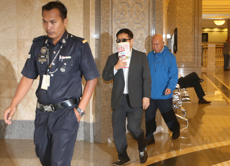 Liew Chee Wah (in sunglasses) and Ng Poh Weng (in blue jacket) are two of four sentenced to eight years for money laundering and collecting deposits illegally at the Court of Appeals in Putrajaya February 21, 2018. u00e2u20acu201d Picture by Razak Ghazali