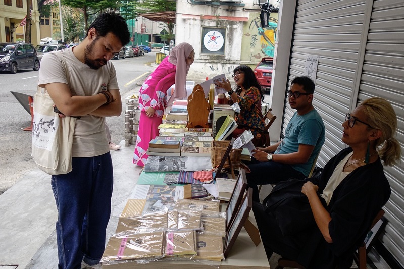 People browse at the items on sale at the  mini arts bazaar.