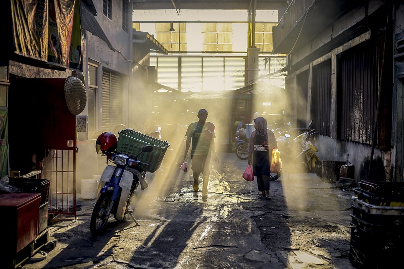 Rays of light stream through open windows at a wholesale wet market in Chow Kit as people go about their morning routine in Kuala Lumpur February 28, 2018. u00e2u20acu201d Picture by Firdaus Latif
