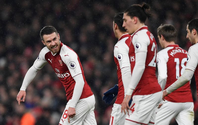 Arsenalu00e2u20acu2122s Aaron Ramsey celebrates scoring their third goal with Mesut Ozil and team mates during their Premier League match against Everton in Emirates Stadium, London, February 3, 2018. u00e2u20acu201d Reuters pic