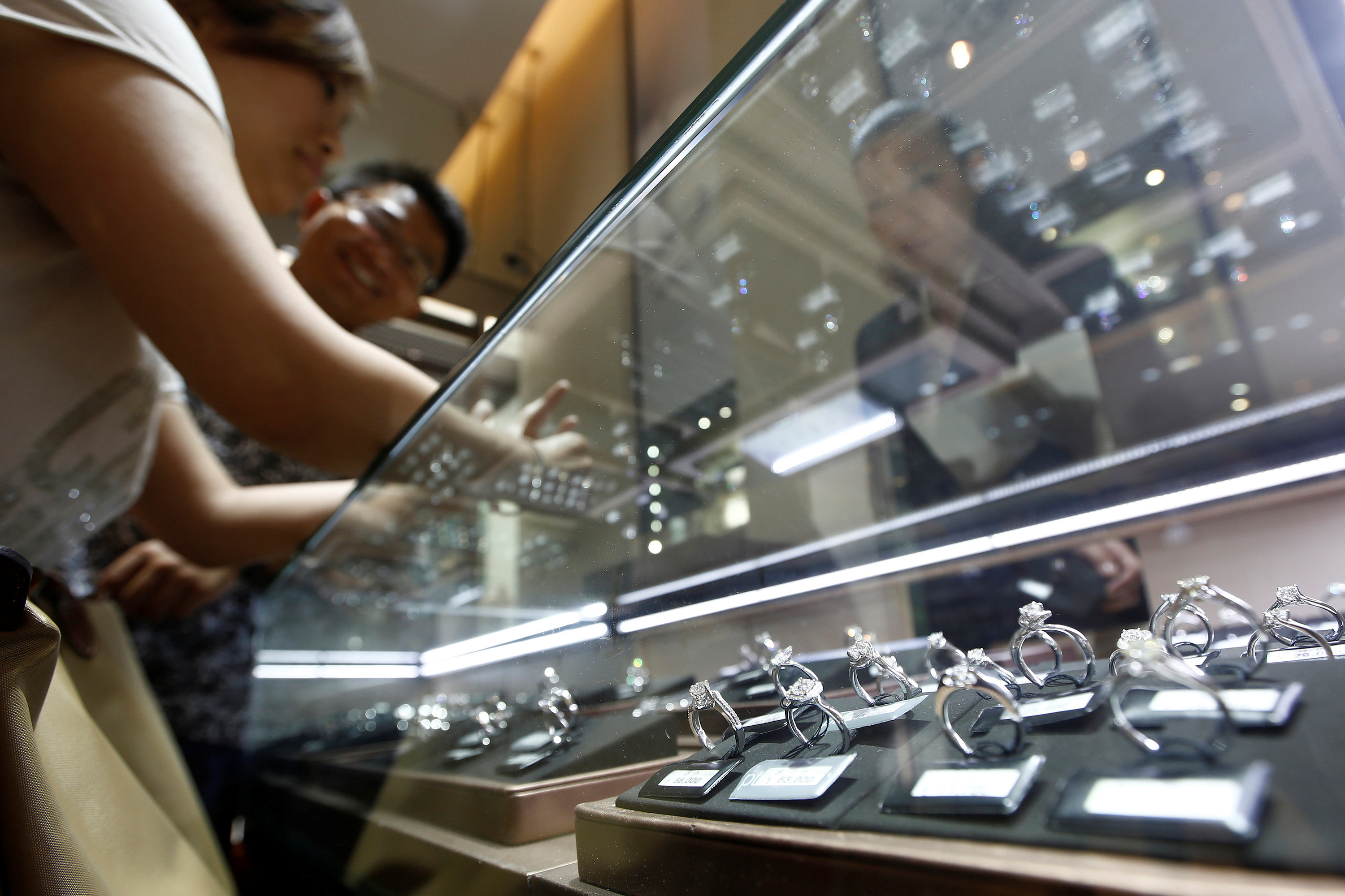 A couple selects diamond rings at a Chow Tai Fook store in Shanghai, China September 16, 2013. u00e2u20acu201d Reuters pic