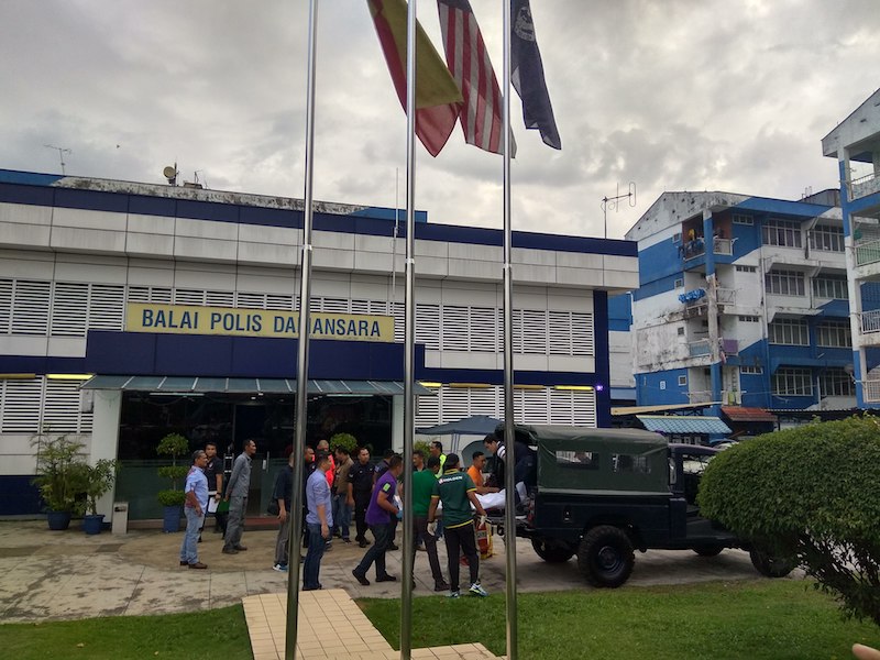 Police load the victim's body onto a police truck at the Damansara police station on February 5, 2018. u00e2u20acu201d Picture by Kenneth Tee
