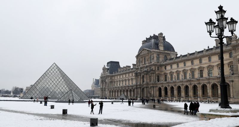 Tourists walk in the snow at the Louvre Pyramid in Paris as winter weather continues in northern France February 10, 2018. u00e2u20acu2022 Reuters pic