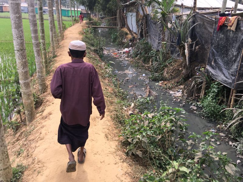 A man walks between a rice field and the shacks of Rohingya refugees living on the land of Bangladeshi farmer Jorina Katun near the Kutapalong refugee camp in the Cox's Bazar district of Bangladesh. u00e2u20acu2022 Reuters pic