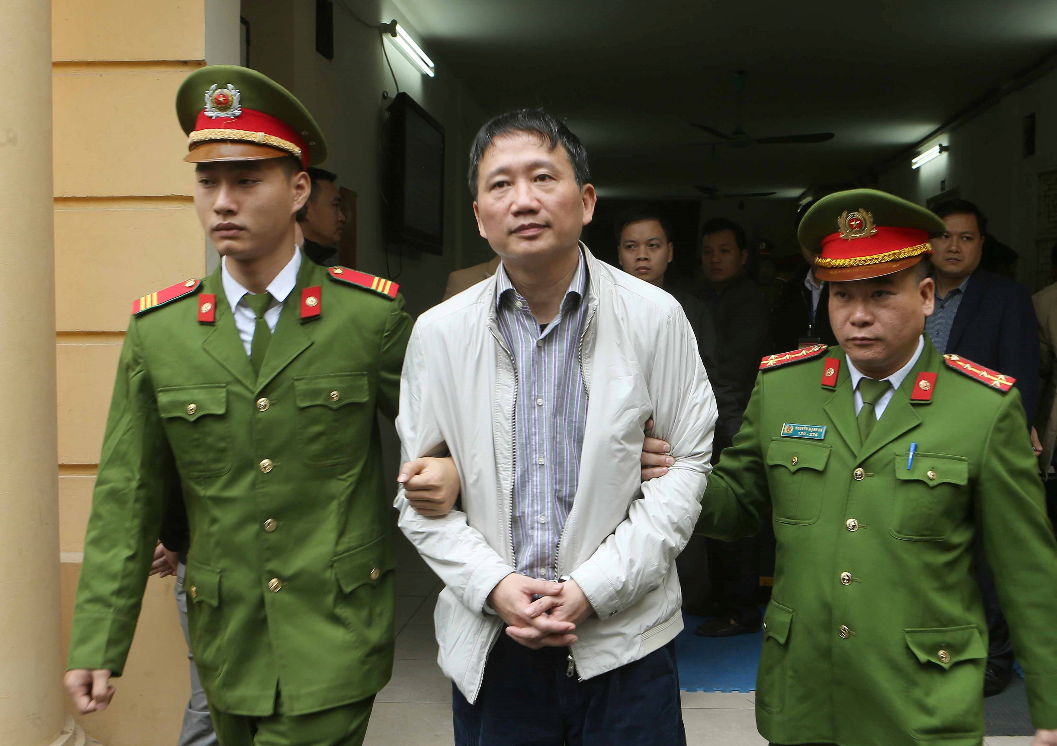 PVC's former chairman Trinh Xuan Thanh is escorted by police officers from a court to prison after verdict session in Hanoi, Vietnam January 22, 2018. u00e2u20acu201d Reuters pic