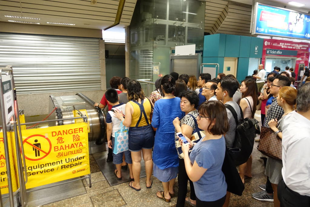 Evening commuters crowding near the escalator at Ang Mo Kio MRT station. The middle escalator at the station was cordoned off after it was seen emitting smoke on Monday afternoon. u00e2u20acu201d Koh Mui Fong/TODAY pic n