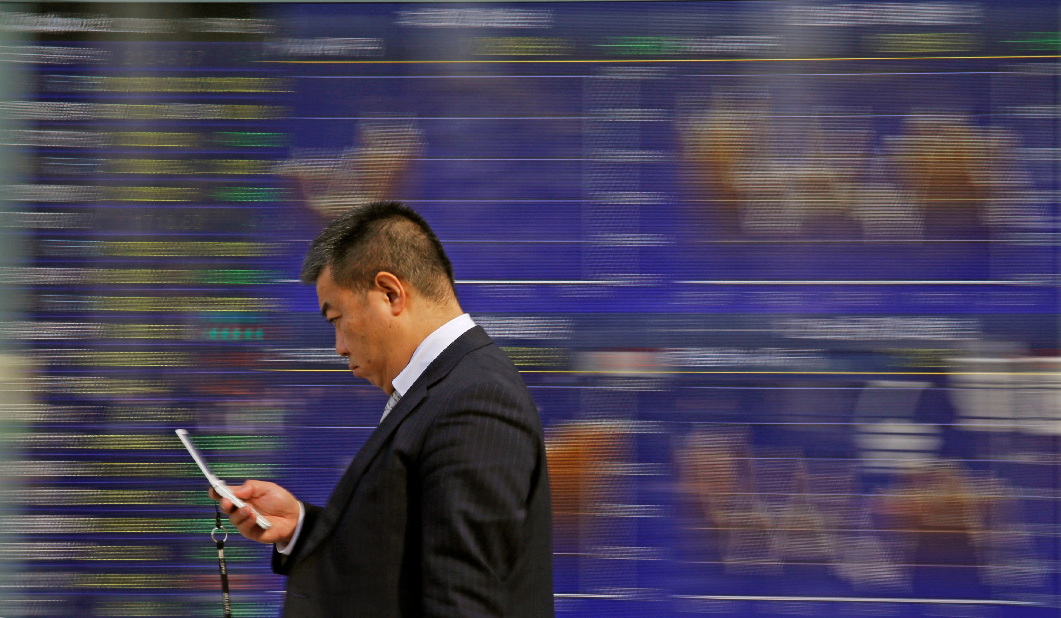 A man walks past an electronic stock quotation board outside a brokerage in Tokyo, Japan, February 9, 2018. u00e2u20acu201d Reuters pic