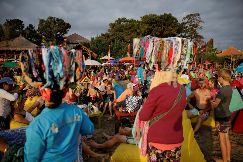 Vendors sell bandanas as tourists watch the sunset on Seminyak beach in Bali, Indonesia August 17, 2017. u00e2u20acu201d Reuters pic 