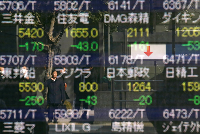 A man is reflected in an electronic stock quotation board outside a brokerage in Tokyo February 9, 2018. u00e2u20acu201d Reuters pic