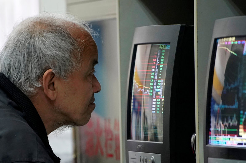 An investor looks at a screen showing stock information at a brokerage house in Shanghai, China February 9, 2018. u00e2u20acu201d Reuters pic