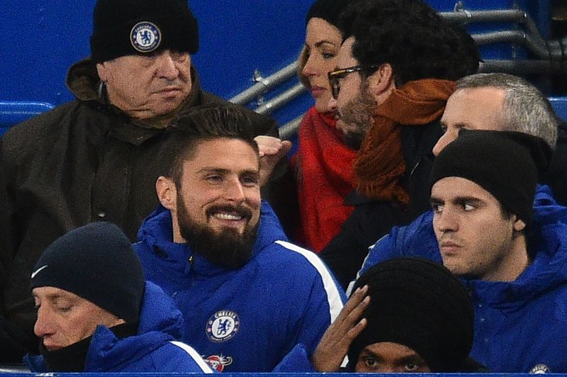 Newly-signed Chelsea striker Olivier Giroud (centre left) sits with the team before the English Premier League match between Chelsea and Bournemouth at Stamford Bridge in London on January 31, 2018. u00e2u20acu201d AFP pic