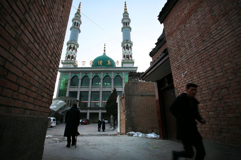 A man runs in front of a mosque at dusk as evening prayers are underway inside, in China's Linxia, Gansu province, home to a large population of ethnic minority Hui Muslims, February 2, 2018. u00e2u20acu201d Reuters pic
