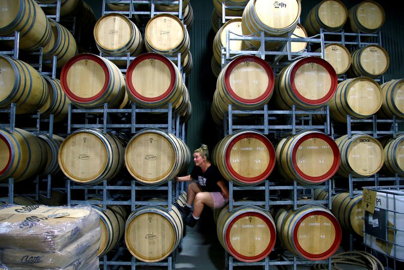 Savannah Peterson, a Trainee Winemaker and daughter of owner Colin Peterson, sits between barrels of wine being stored at Petersons Winery in the Hunter Valley, located north of Sydney in Australia, February 14, 2018. u00e2u20acu201d Reuters pic