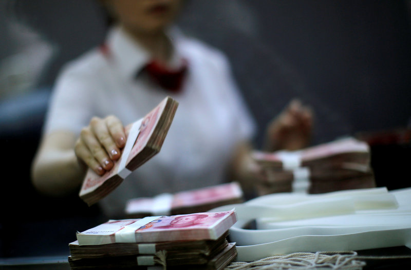 An employee of the Industrial and Commercial Bank of China Ltd (ICBC) counts money at one of the bank's branches at the Shanghai Free Trade Zone in Pudong district, Shanghai September 24, 2014. u00e2u20acu201d Reuters pic 