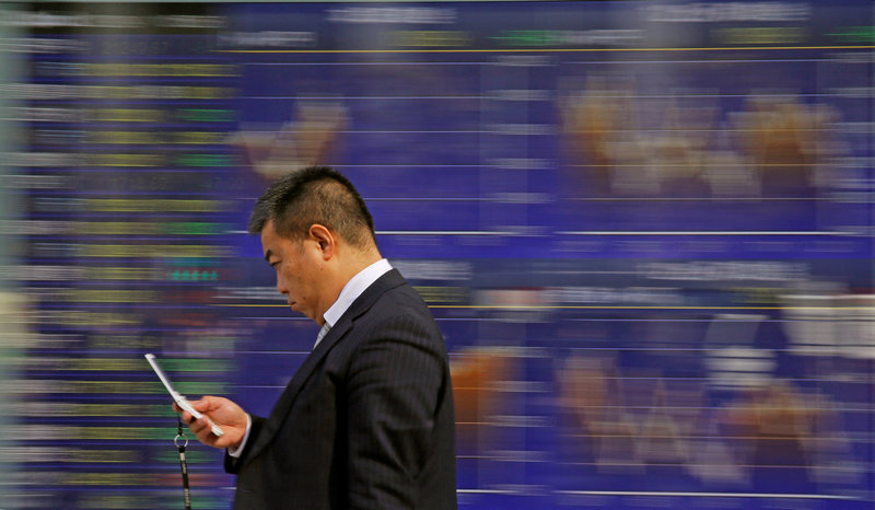 A man walks past an electronic stock quotation board outside a brokerage in Tokyo February 9, 2018. u00e2u20acu201d Reuters pic