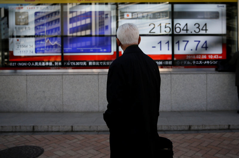 A man looks at an electronic board showing Japan's Nikkei average outside a brokerage in Tokyo February 6, 2018. u00e2u20acu201d Reuters pic 