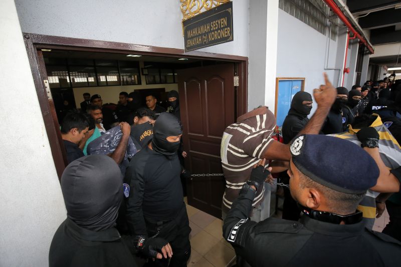 Gang 04 members are being led out of the Ipoh Sessions Court here today after they were charged with  being involved in an organised crime group. u00e2u20acu2022 Picture by Marcus Pheong