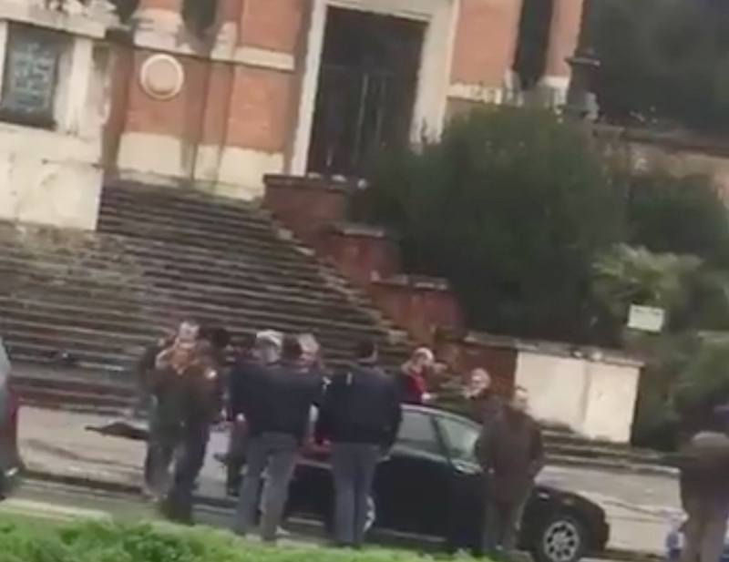 People gather where witnesses say a shooter was arrested in Macerata February 3, 2018 in this still image obtained from social media video. u00e2u20acu201d Picture by Marcelo Mancini via Reuters