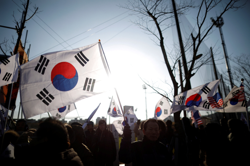 Members of a conservative civic group wave South Korean flags during an anti-North Korea protest before a friendly match between the inter-Korean womenu00e2u20acu2122s ice hockey team and Sweden in Incheon February 4, 2018. u00e2u20acu201d Reuters pic