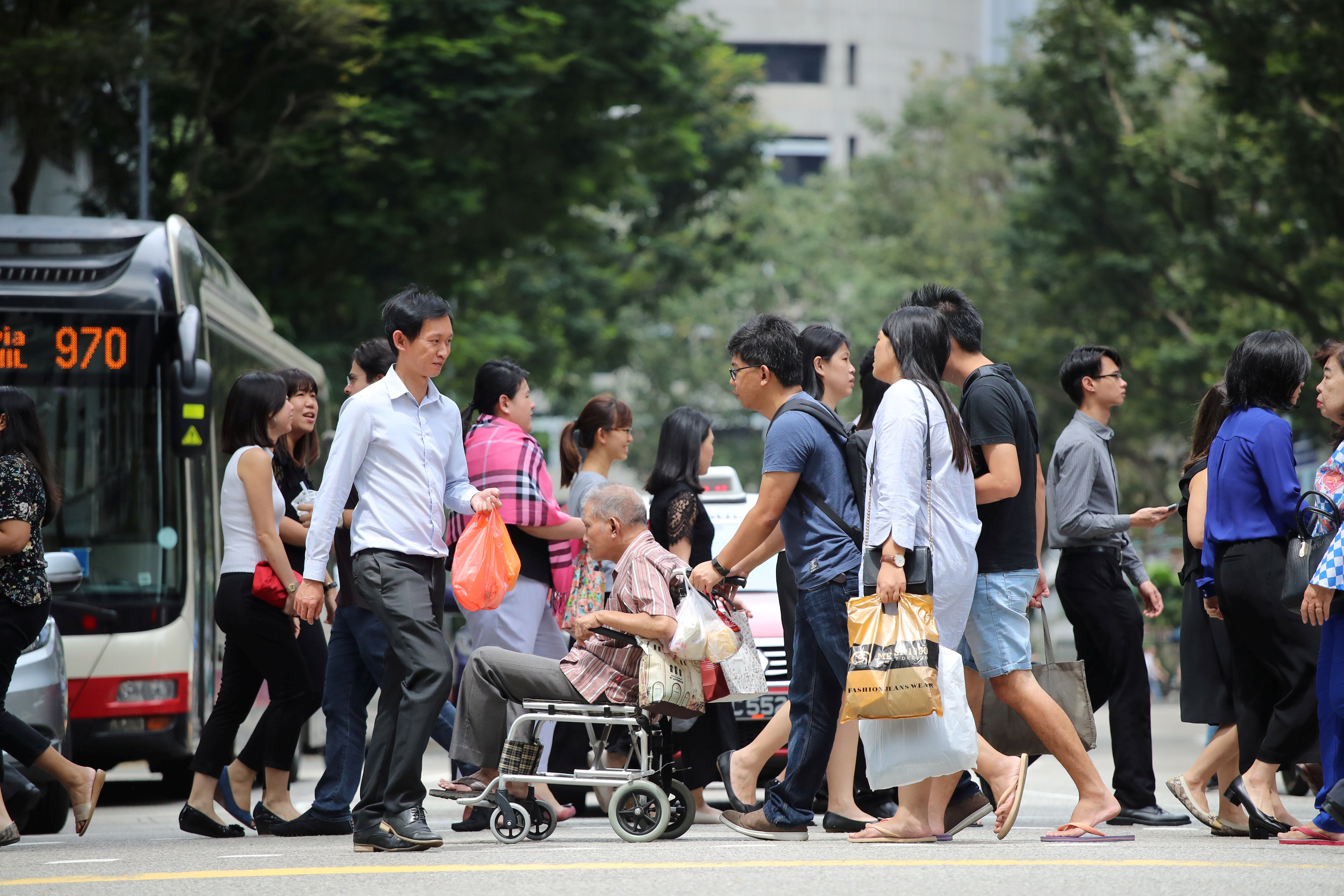A man is wheeled across a pedestrian crossing in Singapore January 16, 2018. u00e2u20acu201d Reuters pic