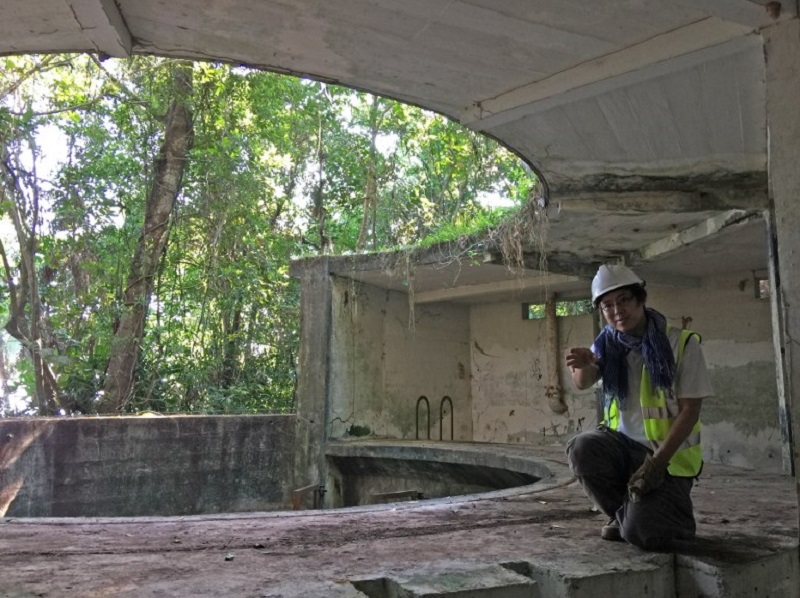 This handout photograph taken on December 22, 2017 and made available by the ISEAS-Yusof Ishak Institute on January 24, 2018 shows archaeologist Lim Chen Sian briefing reporters at a colonial-era gun emplacement tower built by the British in the 1930s on 