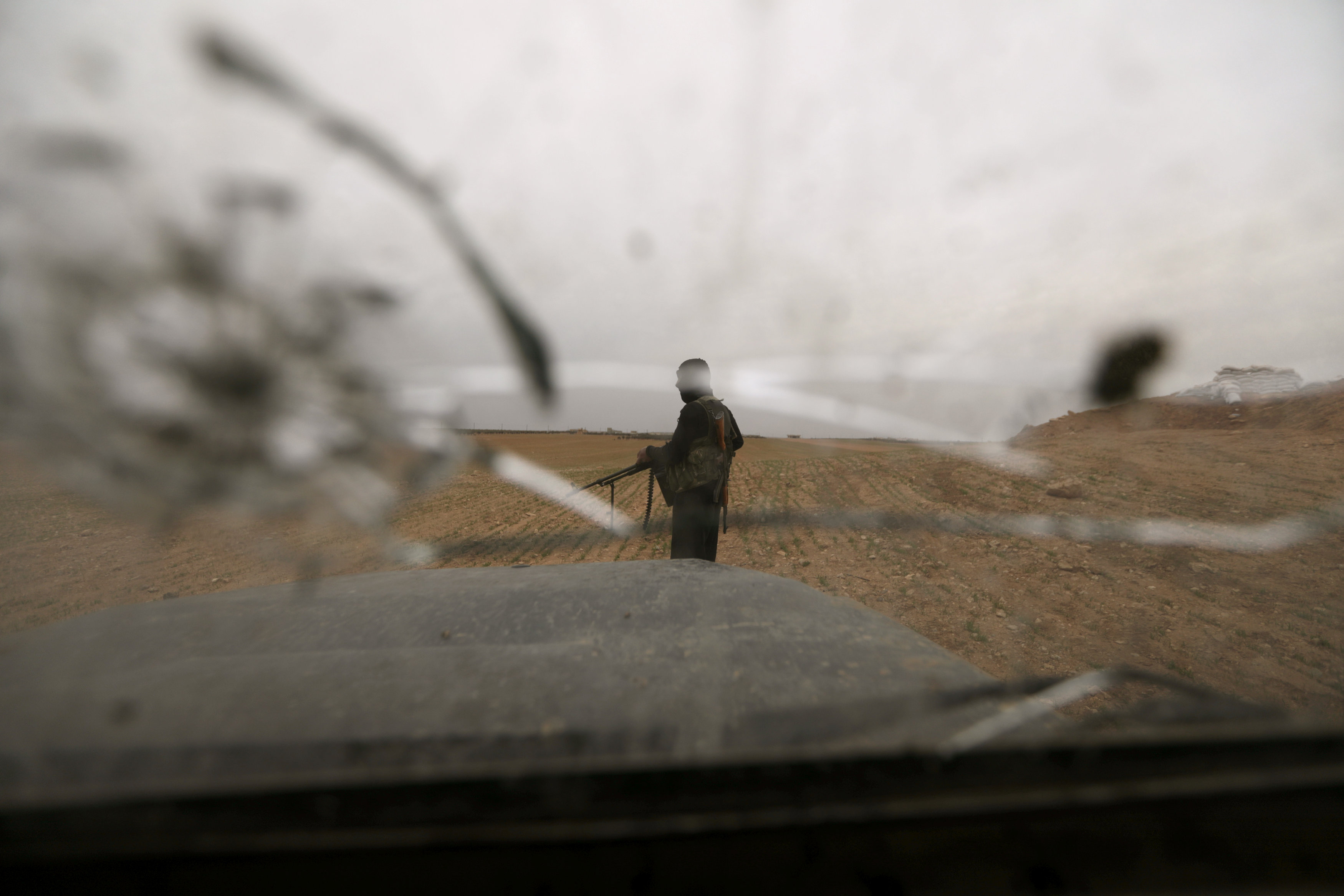 Turkey-backed Free Syrian Army fighter is seen through his vehicle in al Ajami village in east al Bab, Syria February 3,2018. u00e2u20acu201d Reuters pic
