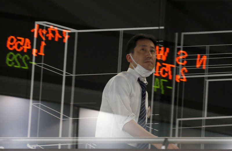 A visitor is seen as market prices are reflected in a glass window at the Tokyo Stock Exchange (TSE) in Tokyo, Japan, February 6, 2018. u00e2u20acu201d Reuters pic