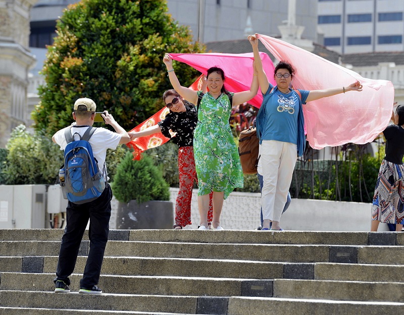 Tourists from China pose for pictures as they visit Dataran Merdeka in Kuala Lumpur February 16 2018. u00e2u20acu201d Picture by Ham Abu Bakar