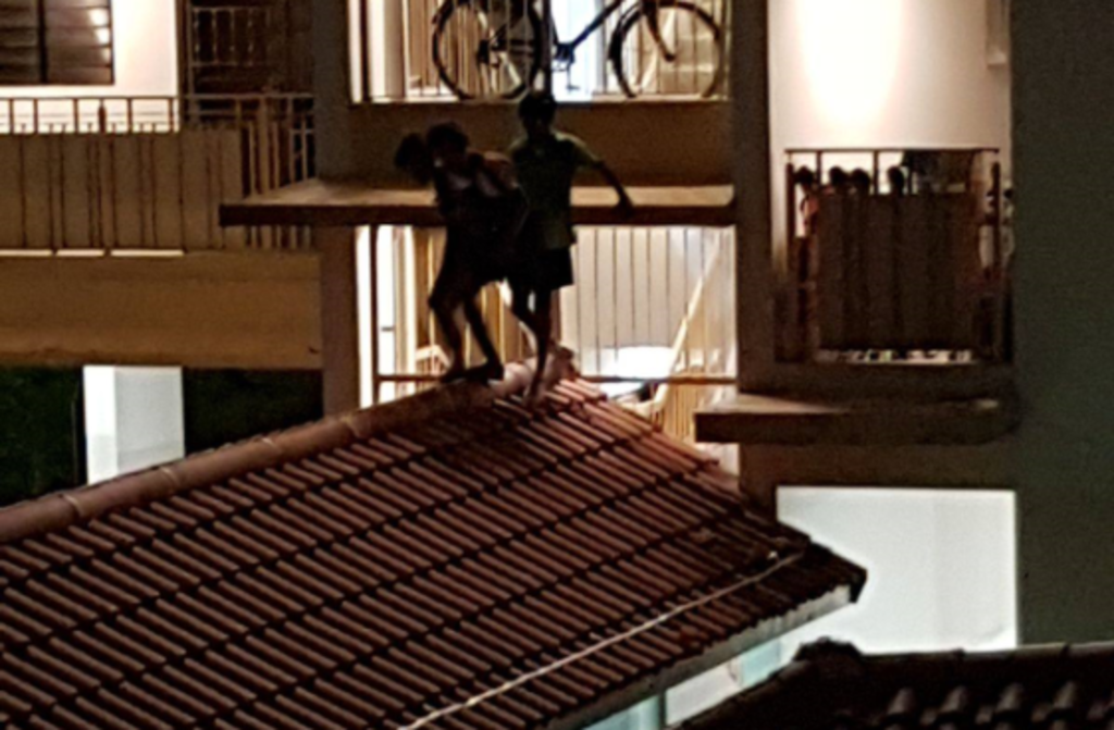 Youths seen on the rooftop of a walkway at Block 438 Yishun Ring Road in June last year. u00e2u20acu201d Picture by Tan Sook Leng/via TODAY