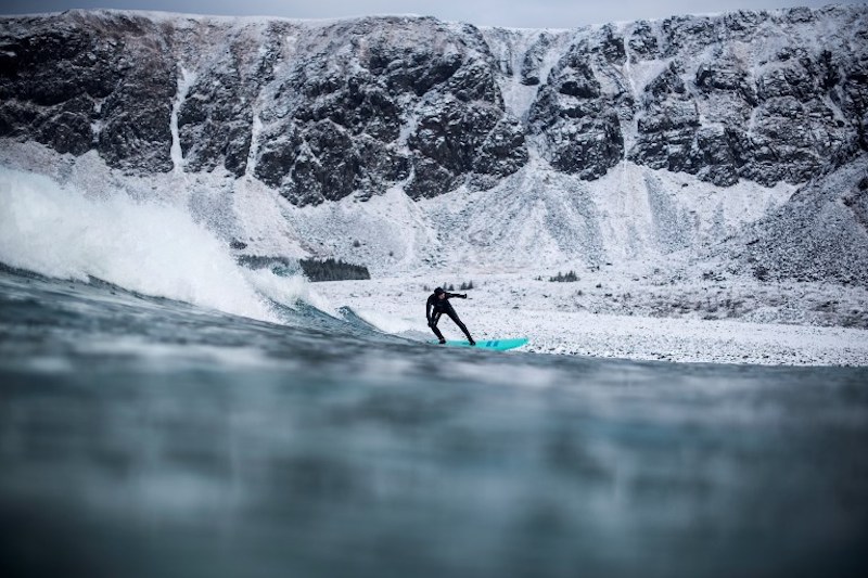 A surfer rides a wave in Unstad, northern Norway, Lofoten islands, within the Arctic Circle March 10, 2018. — AFP pic